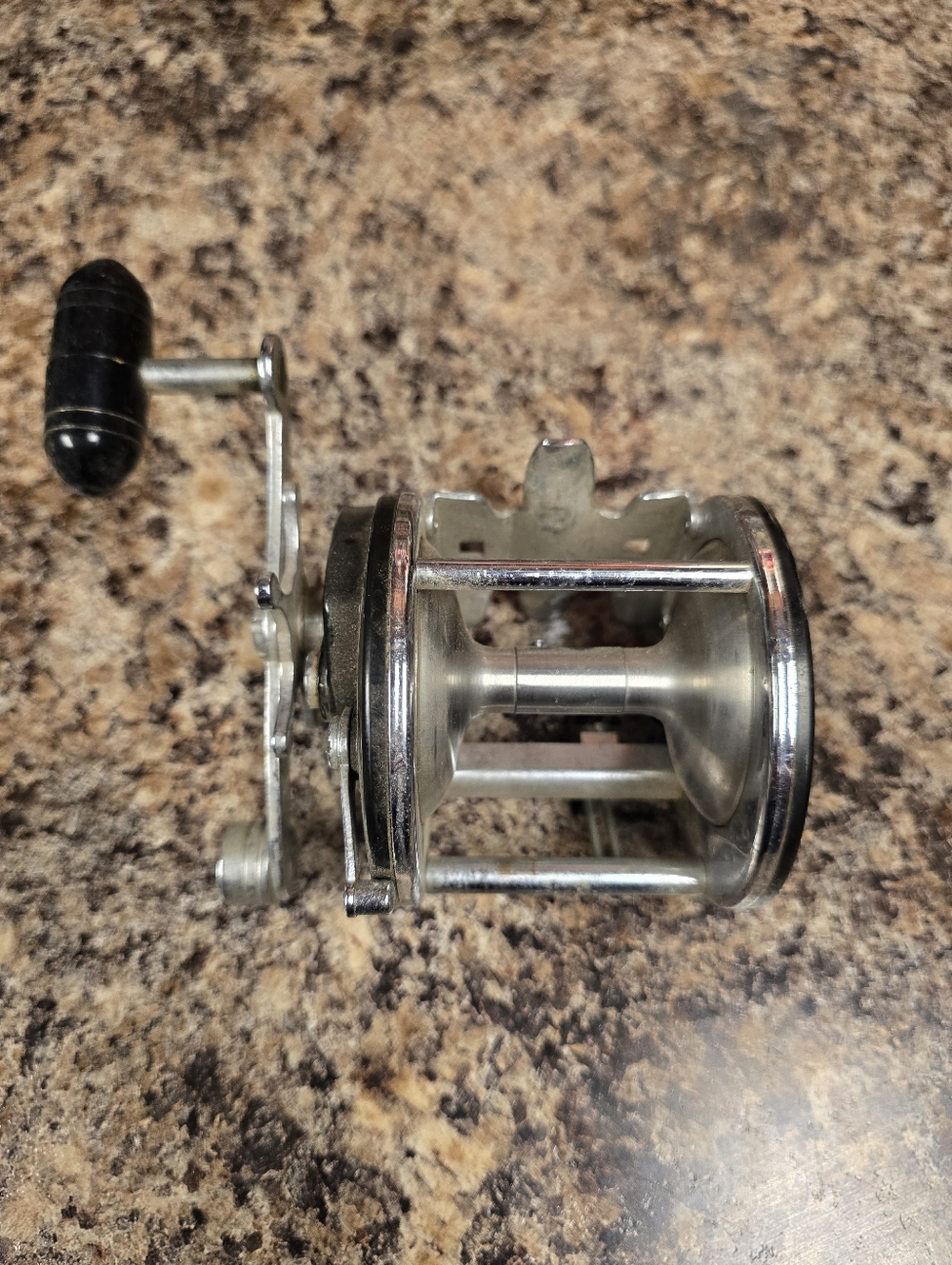 Vintage Round Metal Fishing Reel in Silver and Black